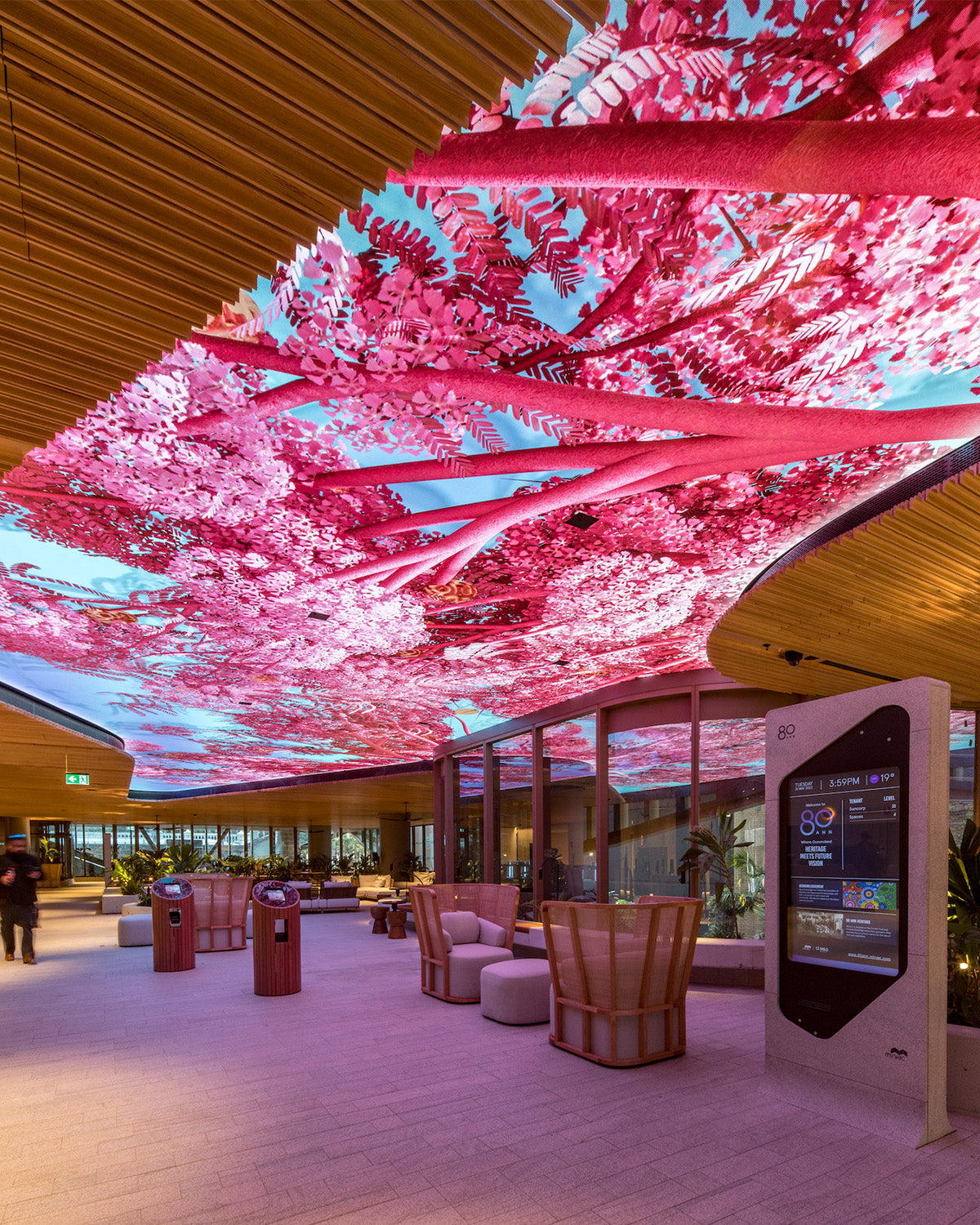 Pink overhead artwork above a lounge space at Heritage Lanes
